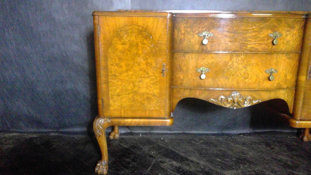 A burr walnut Queen Anne style sideboard featuring two central drawers flanked by cupboard doors, resting on carved cabriole legs with claw and ball feet. View III