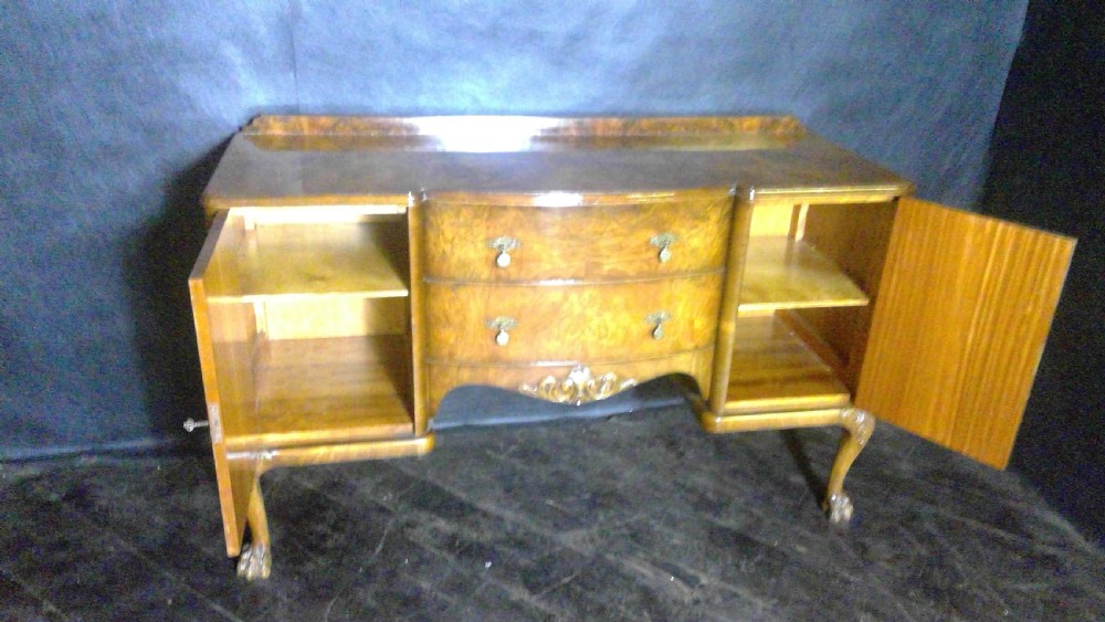 A burr walnut Queen Anne style sideboard featuring two central drawers flanked by cupboard doors, resting on carved cabriole legs with claw and ball feet. View VI