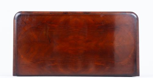 fig 2. An antique Biedermeier mahogany chest of drawers featuring four stacked drawers with book-matched flame veneer, dark keyhole escutcheons, and front bun feet.