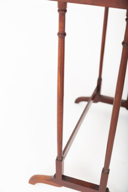 A set of four graduating mahogany nesting tables featuring slender turned legs and splayed trestle feet. View V