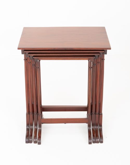 A set of four graduating mahogany nesting tables featuring slender turned legs and splayed trestle feet. View VII