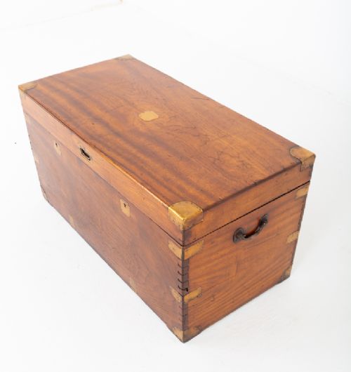 A rectangular camphor wood military campaign trunk featuring brass corner mounts, flush-fitting brass hardware, and iron side carrying handles. View VI