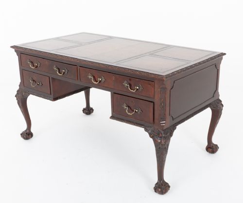 A dark mahogany Chippendale style writing desk featuring an inset leather top, carved cabriole legs with ball-and-claw feet, and brass drawer handles. View VI