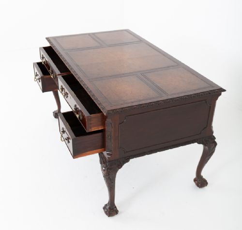 A dark mahogany Chippendale style writing desk featuring an inset leather top, carved cabriole legs with ball-and-claw feet, and brass drawer handles. View XIII