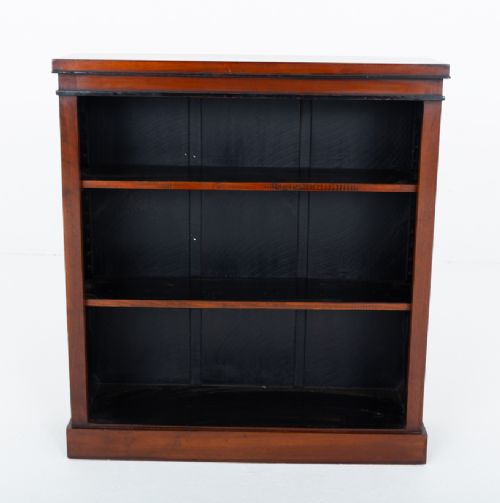 A Victorian mahogany open bookcase featuring open adjustable shelves, a dark interior, a upper moulded border, and a low plinth base. View III
