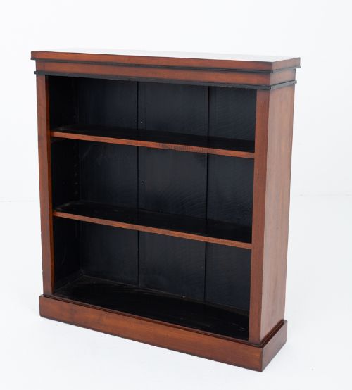 A Victorian mahogany open bookcase featuring open adjustable shelves, a dark interior, a upper moulded border, and a low plinth base. View V