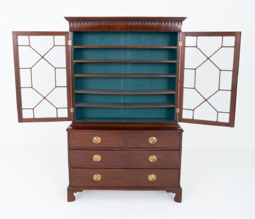 A Georgian mahogany two-piece bookcase on chest featuring an astragal glazed upper cabinet, dentil cornice, and a chest of drawers resting on bracket feet. View V