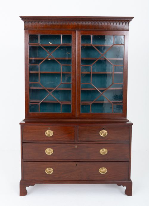 A Georgian mahogany two-piece bookcase on chest featuring an astragal glazed upper cabinet, dentil cornice, and a chest of drawers resting on bracket feet. View VI