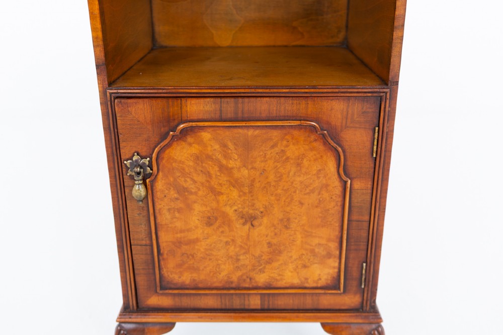 A Queen Anne style walnut bedside cabinet with an open top shelf, a single cupboard door with burr walnut veneer, a brass teardrop handle, and carved cabriole legs. View II