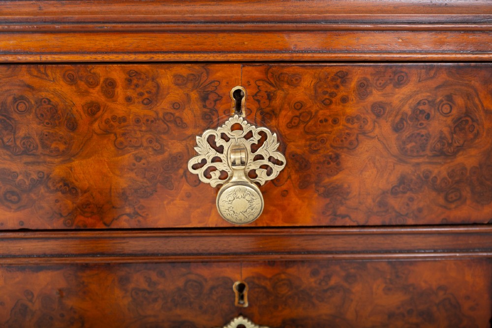 A Queen Anne style burr walnut kneehole desk featuring an inset dark leather writing top, brass drop handles, and cabriole legs. View V