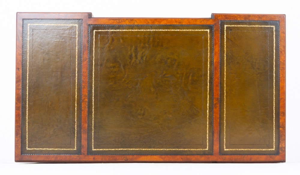 A Queen Anne style burr walnut kneehole desk featuring an inset dark leather writing top, brass drop handles, and cabriole legs. View VIII