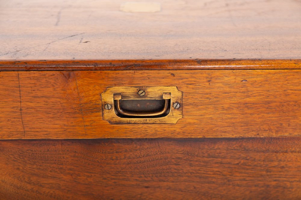 A rectangular camphor wood military campaign trunk featuring brass corner mounts, flush-fitting brass hardware, and iron side carrying handles. View II