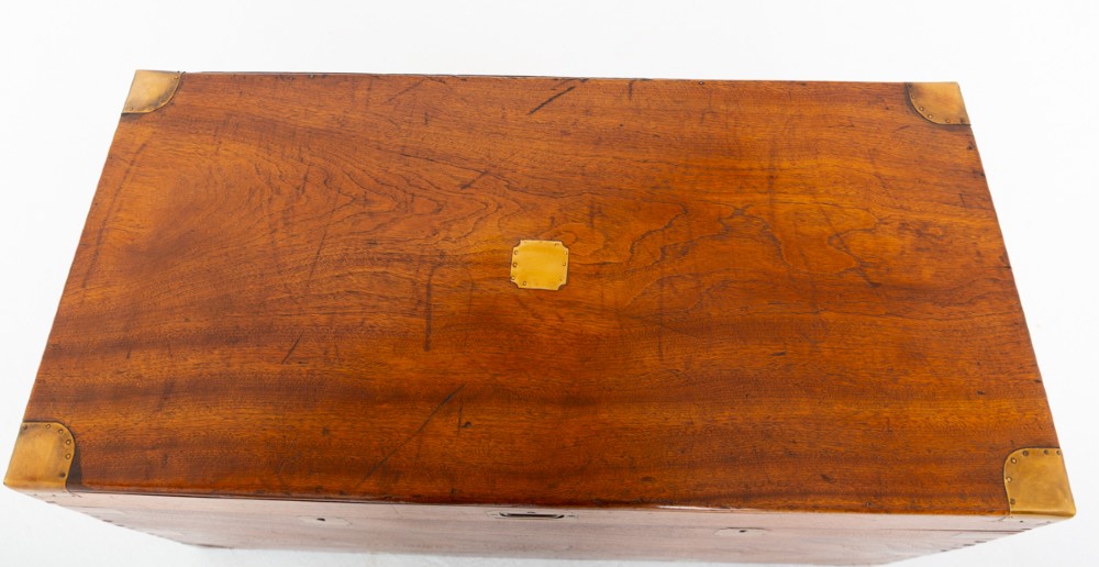 A rectangular camphor wood military campaign trunk featuring brass corner mounts, flush-fitting brass hardware, and iron side carrying handles. View VII