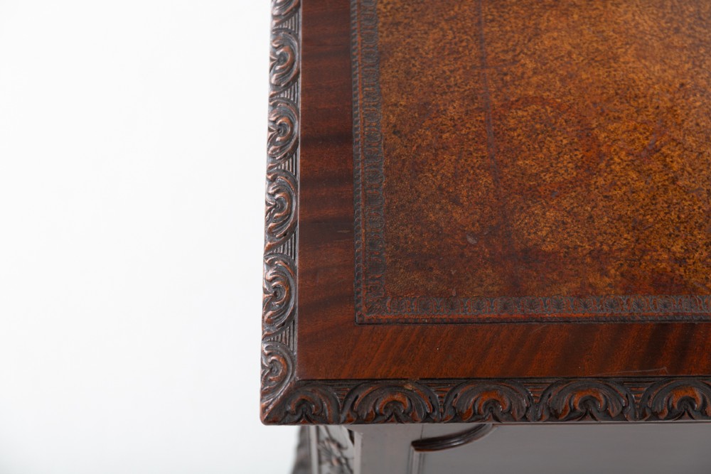 A dark mahogany Chippendale style writing desk featuring an inset leather top, carved cabriole legs with ball-and-claw feet, and brass drawer handles. View II