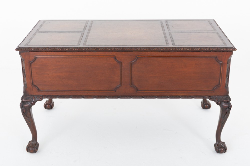 A dark mahogany Chippendale style writing desk featuring an inset leather top, carved cabriole legs with ball-and-claw feet, and brass drawer handles. View XI