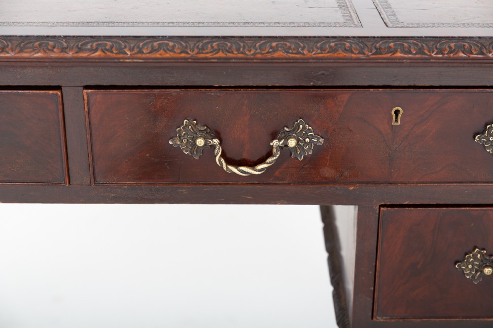 A dark mahogany Chippendale style writing desk featuring an inset leather top, carved cabriole legs with ball-and-claw feet, and brass drawer handles. View XII