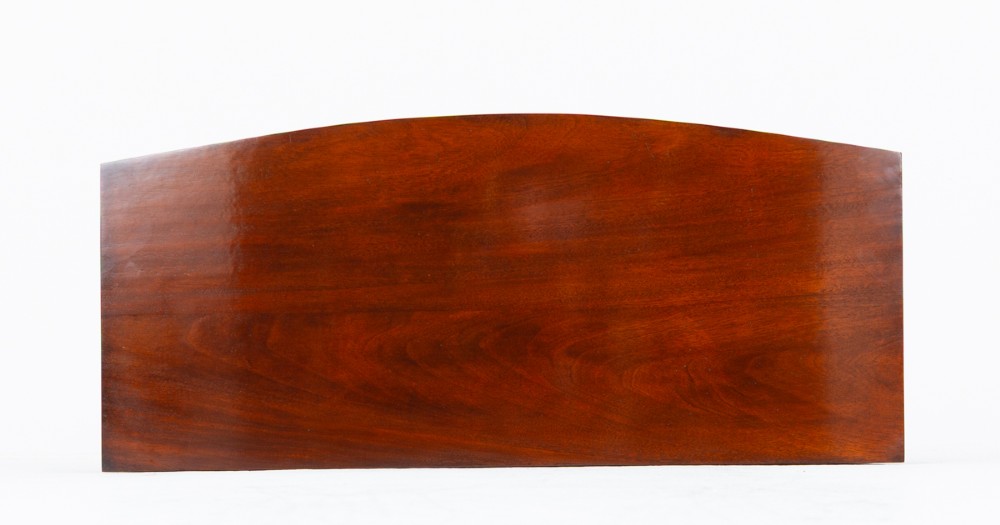 A Regency mahogany bow-front side table featuring two drawers with brass ring handles and slender square tapered legs. View V