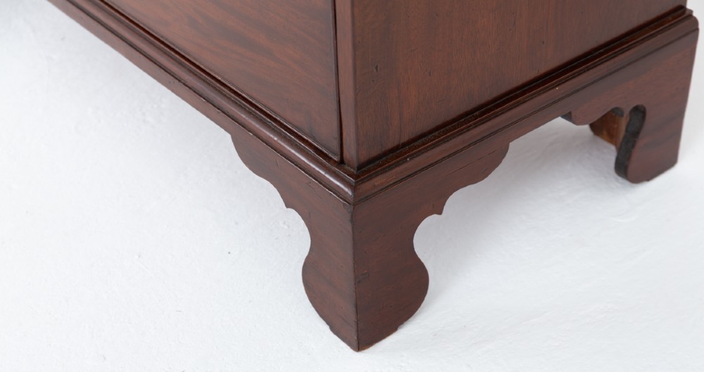 A Georgian mahogany two-piece bookcase on chest featuring an astragal glazed upper cabinet, dentil cornice, and a chest of drawers resting on bracket feet. View IV