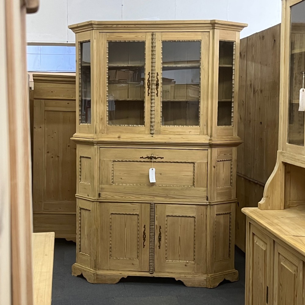A large natural pine secretaire bookcase featuring glazed upper doors, a fold-down desk surface with internal drawers, and a lower two-door cupboard. View II