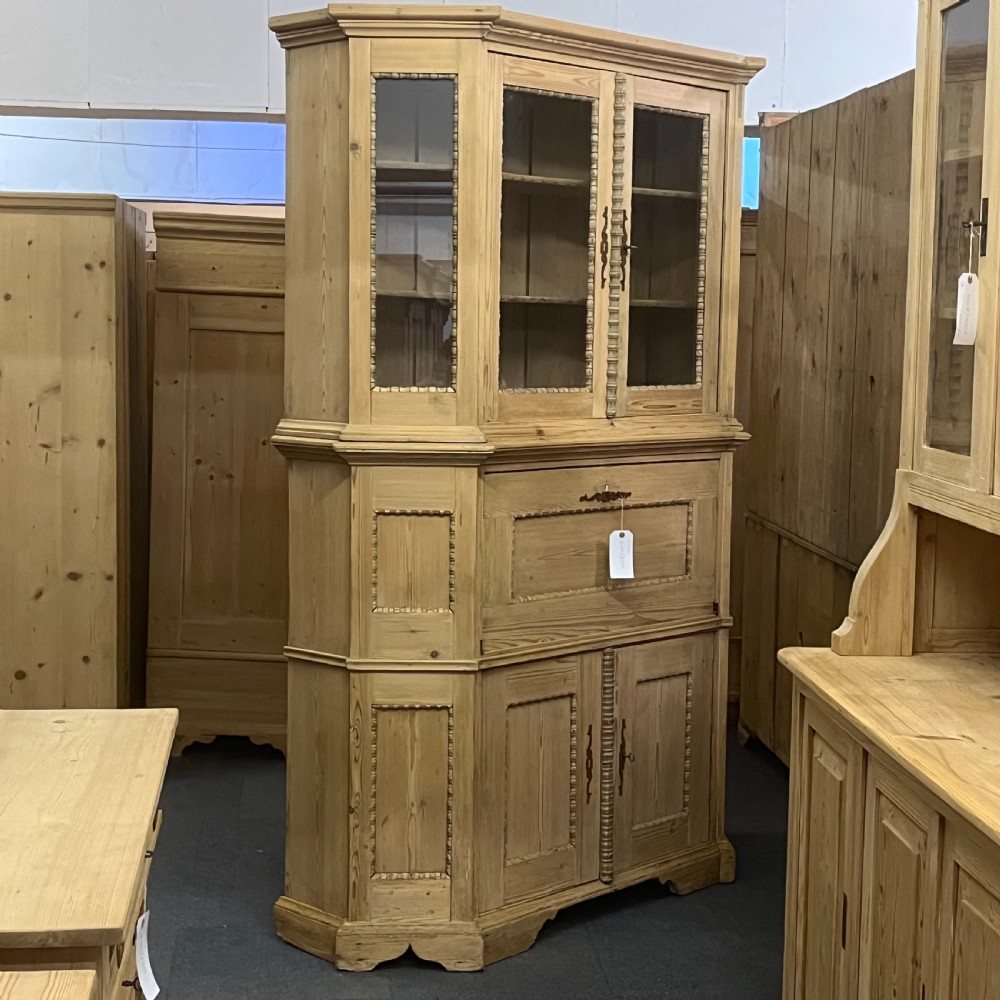 A large natural pine secretaire bookcase featuring glazed upper doors, a fold-down desk surface with internal drawers, and a lower two-door cupboard. View XII