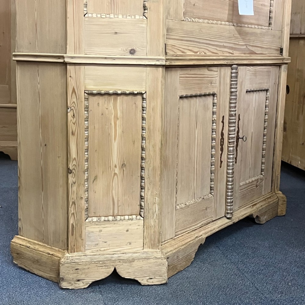 A large natural pine secretaire bookcase featuring glazed upper doors, a fold-down desk surface with internal drawers, and a lower two-door cupboard. View XIII