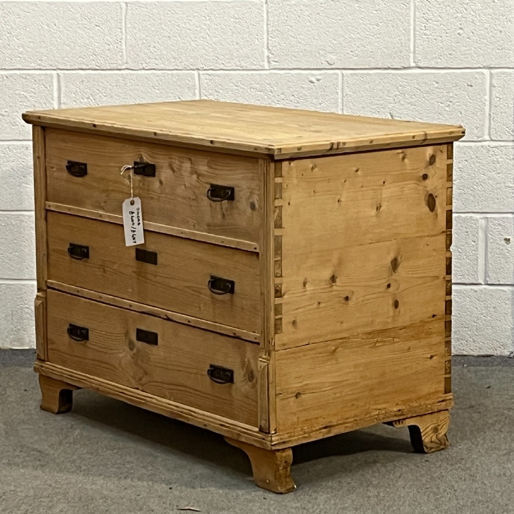 A large natural pine mule chest featuring an open hinged lid above lower drawers with dark metal pull handles and bracket feet. View II
