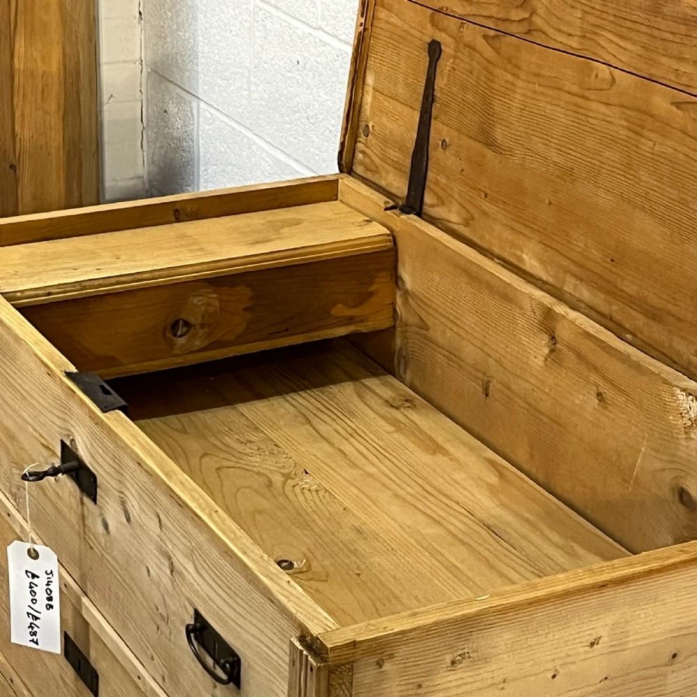A large natural pine mule chest featuring an open hinged lid above lower drawers with dark metal pull handles and bracket feet. View VIII