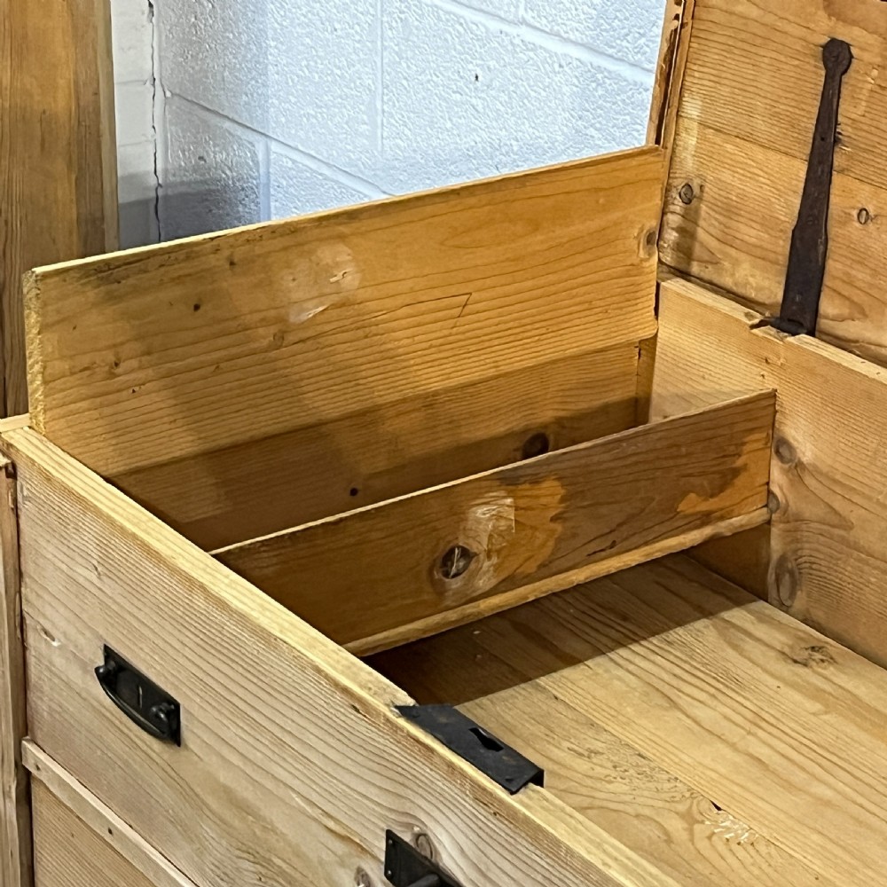 A large natural pine mule chest featuring an open hinged lid above lower drawers with dark metal pull handles and bracket feet. View IX