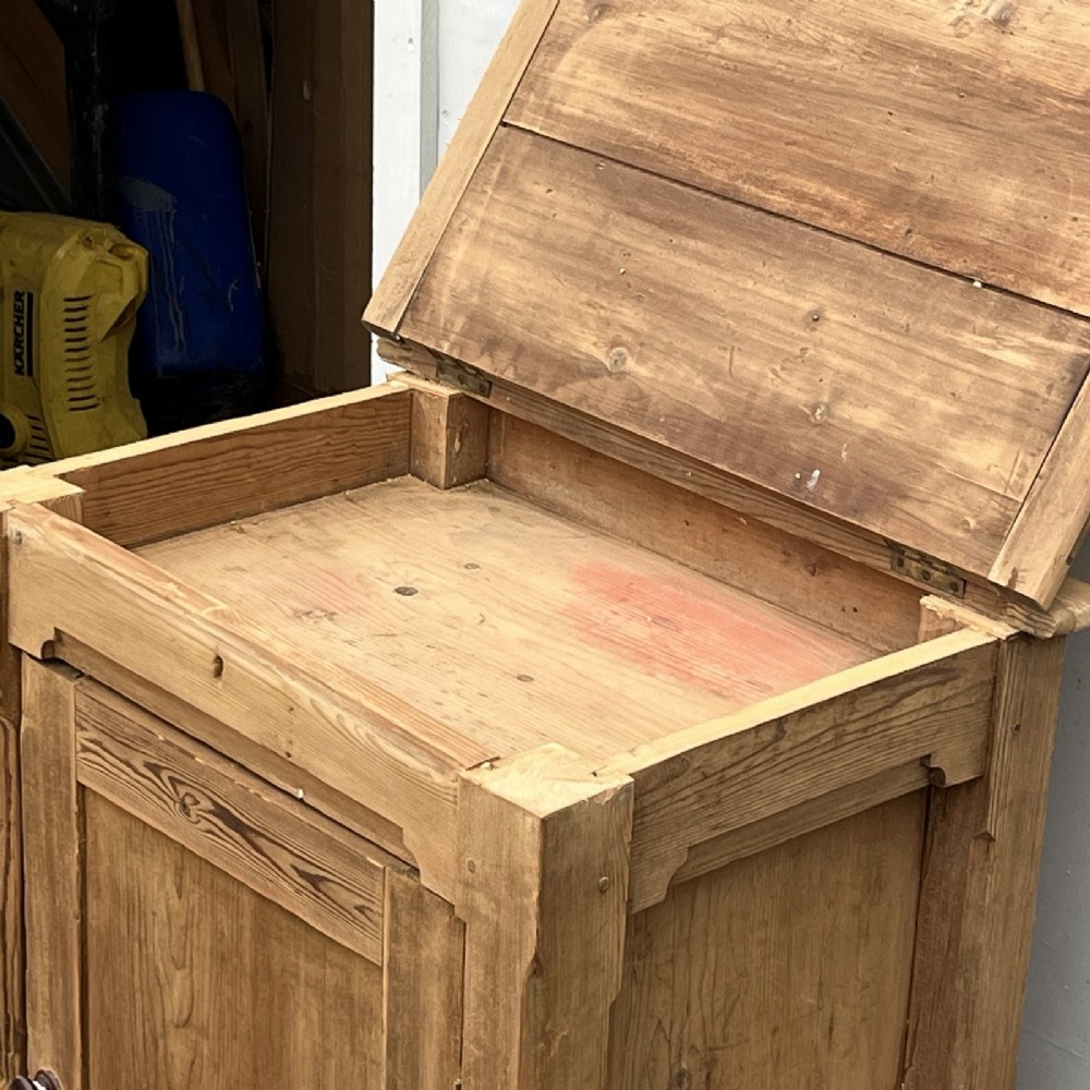 An antique natural pine church lectern cupboard featuring a hinged sloped top, single panelled door, and turned bun feet. View IV