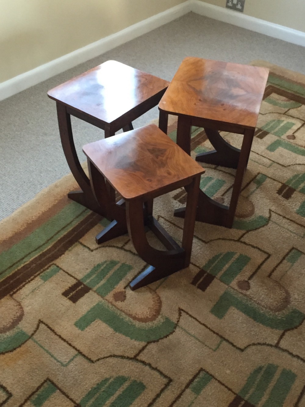 A nest of three Walnut Art Deco side tables.