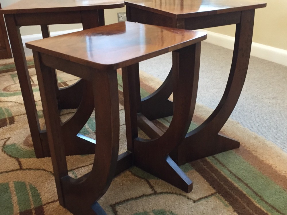 A nest of three Walnut Art Deco side tables. View II