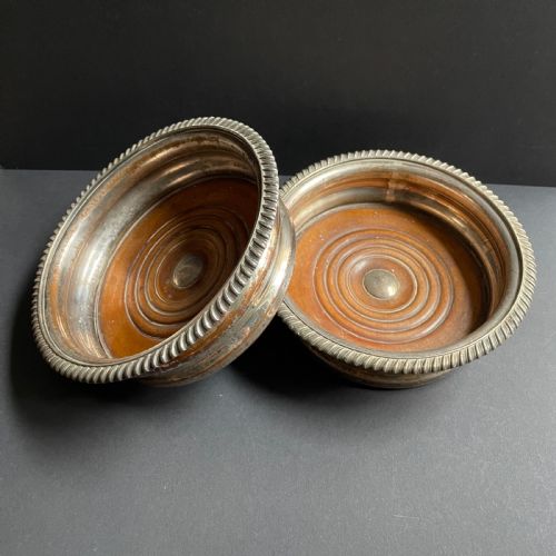 fig 2. A pair of antique Georgian Old Sheffield Plate wine coasters featuring gadrooned rims and turned wooden bases.