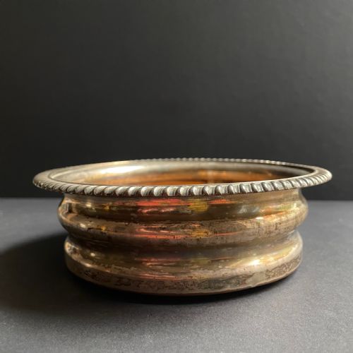 fig 3. A pair of antique Georgian Old Sheffield Plate wine coasters featuring gadrooned rims and turned wooden bases.