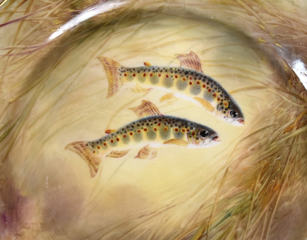 A circular porcelain cabinet plate with hand-painted trout amongst reeds and a gold gilded edge. View II