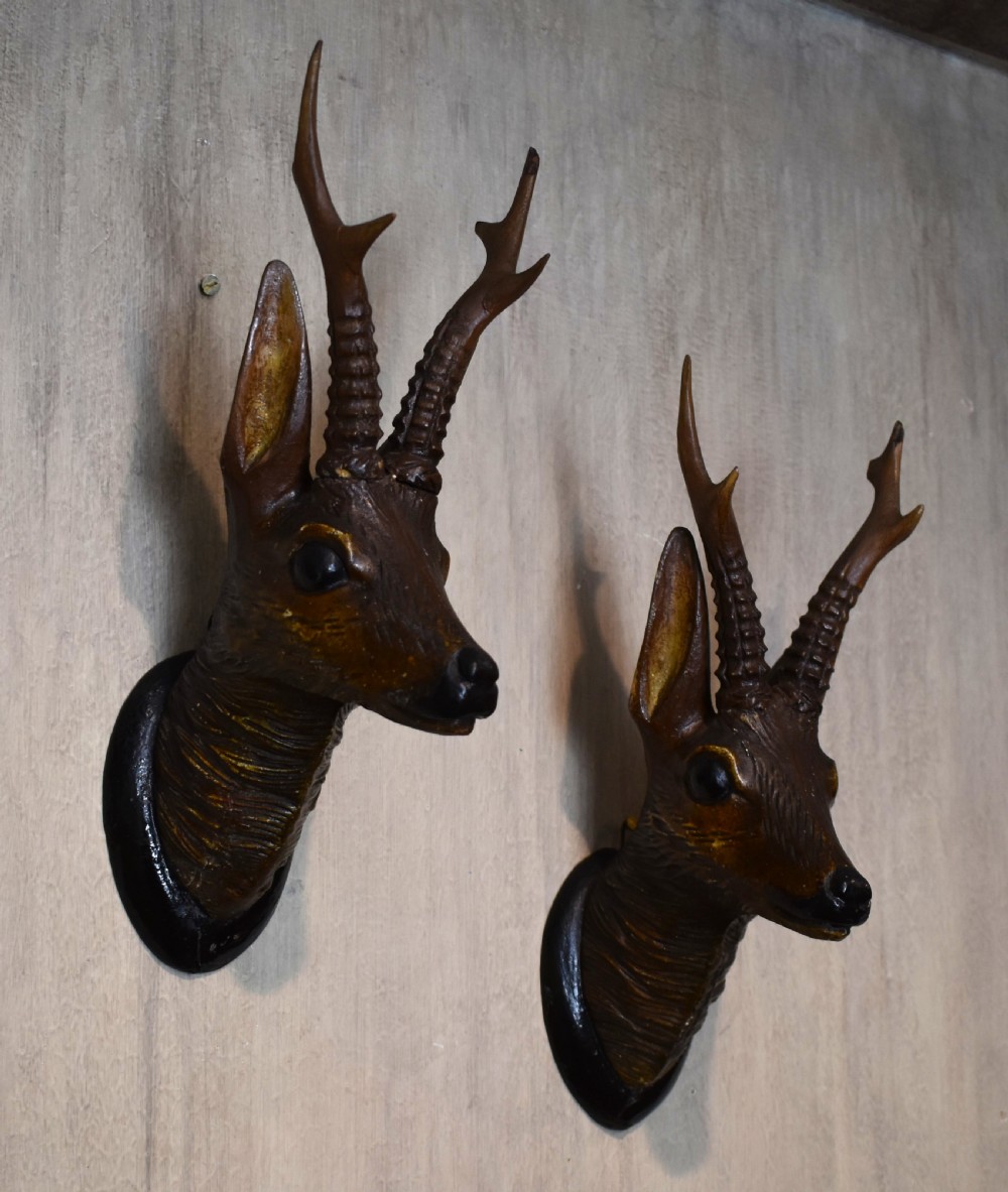 A pair of Black Forest carved wood deer heads