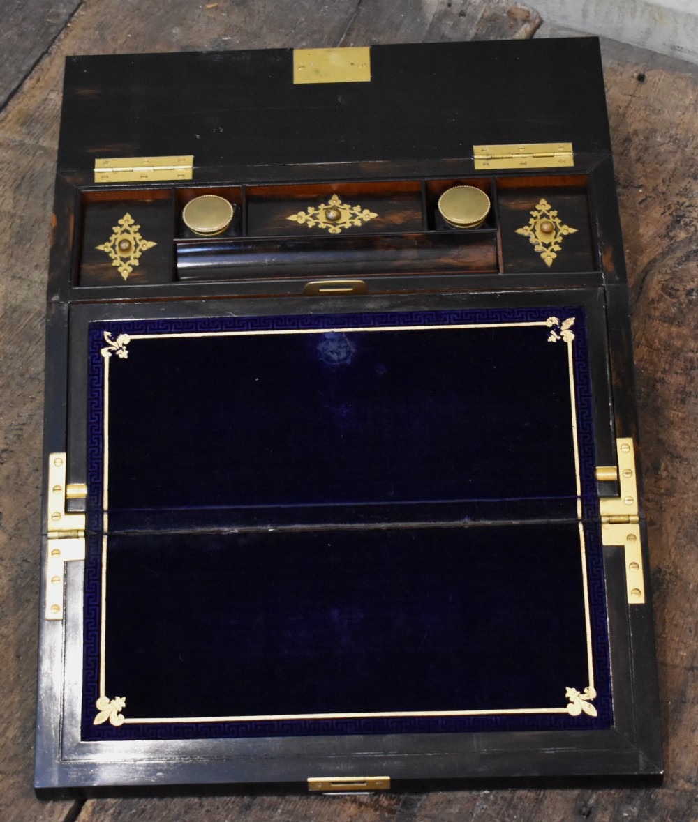 A closed rectangular wooden writing slope crafted from highly figured ash timber with ornate brass straps and corner mounts. View V