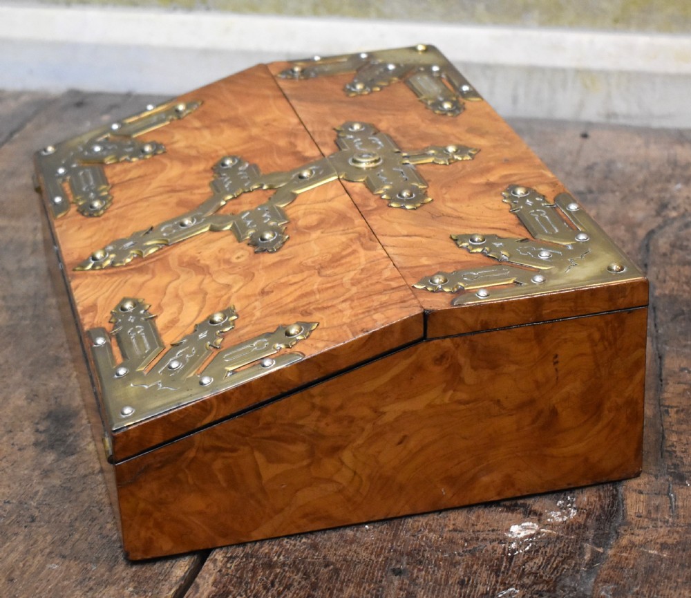 A closed rectangular wooden writing slope crafted from highly figured ash timber with ornate brass straps and corner mounts. View VI
