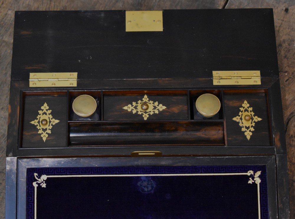 A closed rectangular wooden writing slope crafted from highly figured ash timber with ornate brass straps and corner mounts. View VII