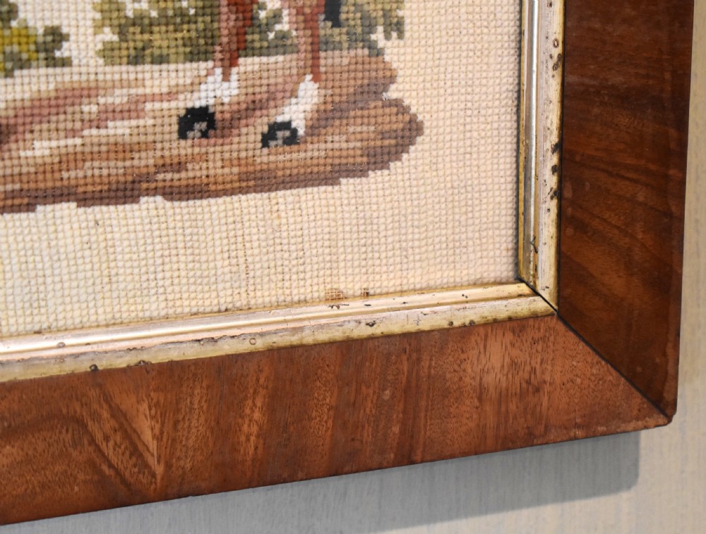 A square framed Victorian needlework picture depicting a brown saddled horse standing in a landscape within a wide wooden frame with a gilded inner slip. View III