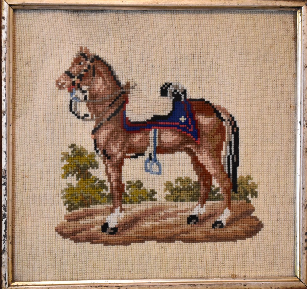 A square framed Victorian needlework picture depicting a brown saddled horse standing in a landscape within a wide wooden frame with a gilded inner slip. View IV