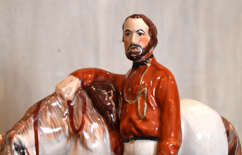 Victorian Staffordshire pottery figure representing Giuseppe Garibaldi standing beside a horse on a moulded ceramic base. View II