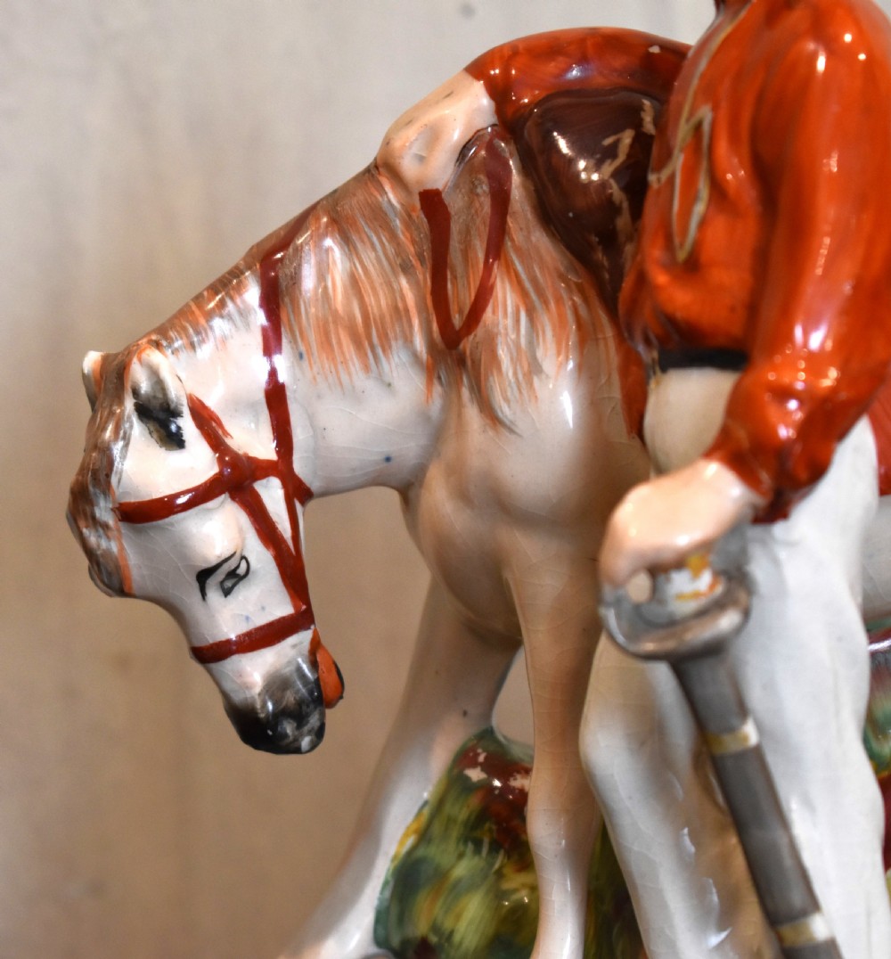 Victorian Staffordshire pottery figure representing Giuseppe Garibaldi standing beside a horse on a moulded ceramic base. View III