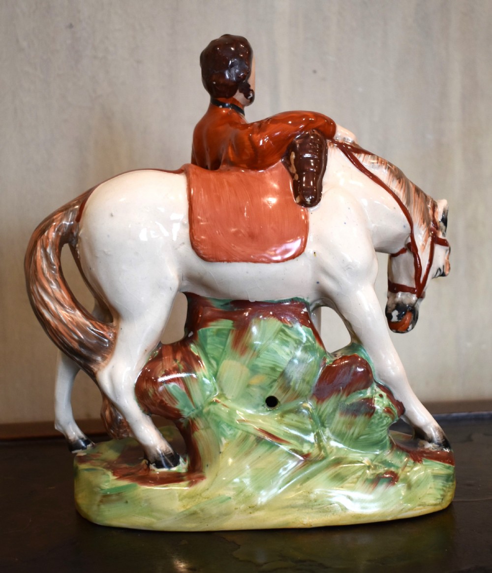 Victorian Staffordshire pottery figure representing Giuseppe Garibaldi standing beside a horse on a moulded ceramic base. View IV