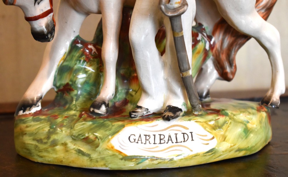Victorian Staffordshire pottery figure representing Giuseppe Garibaldi standing beside a horse on a moulded ceramic base. View V