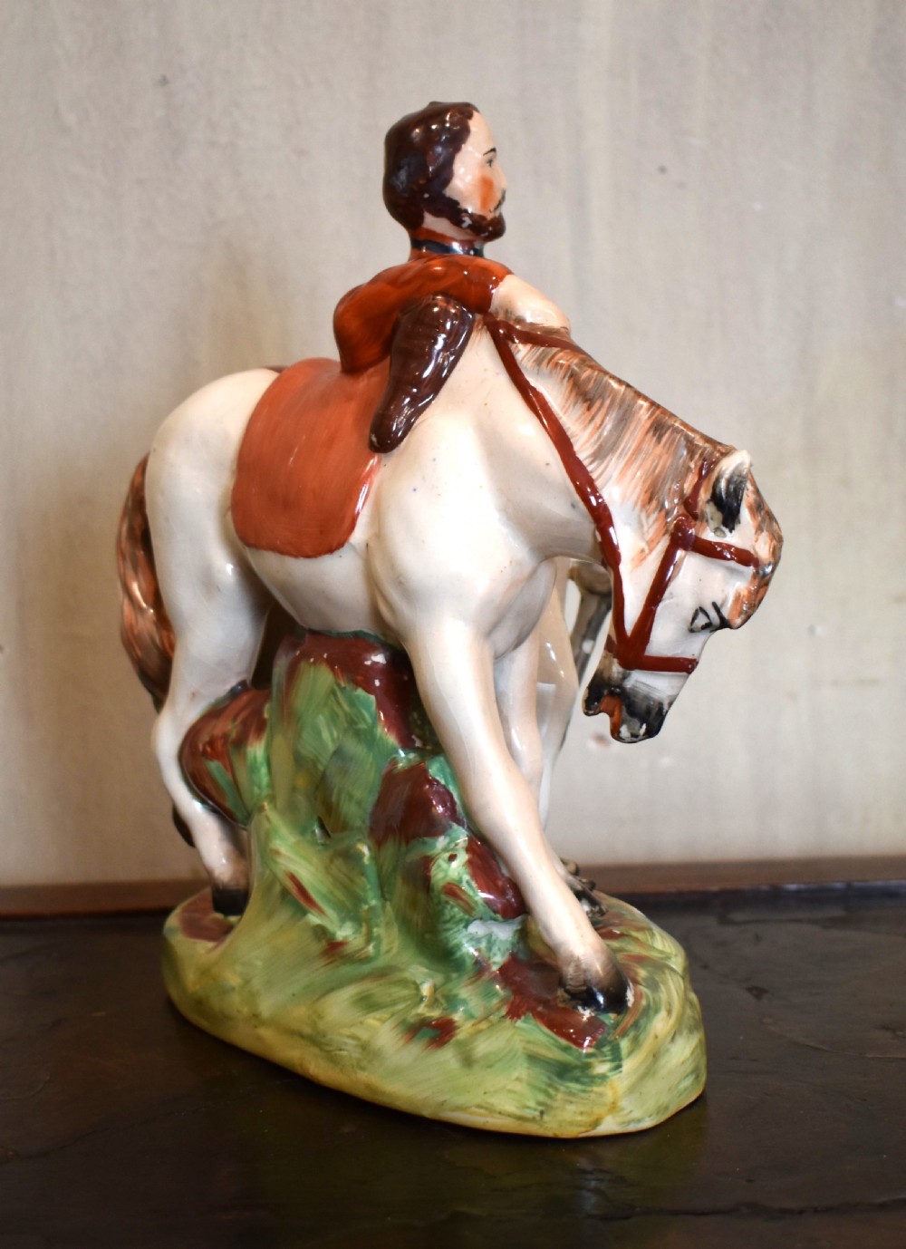 Victorian Staffordshire pottery figure representing Giuseppe Garibaldi standing beside a horse on a moulded ceramic base. View VI