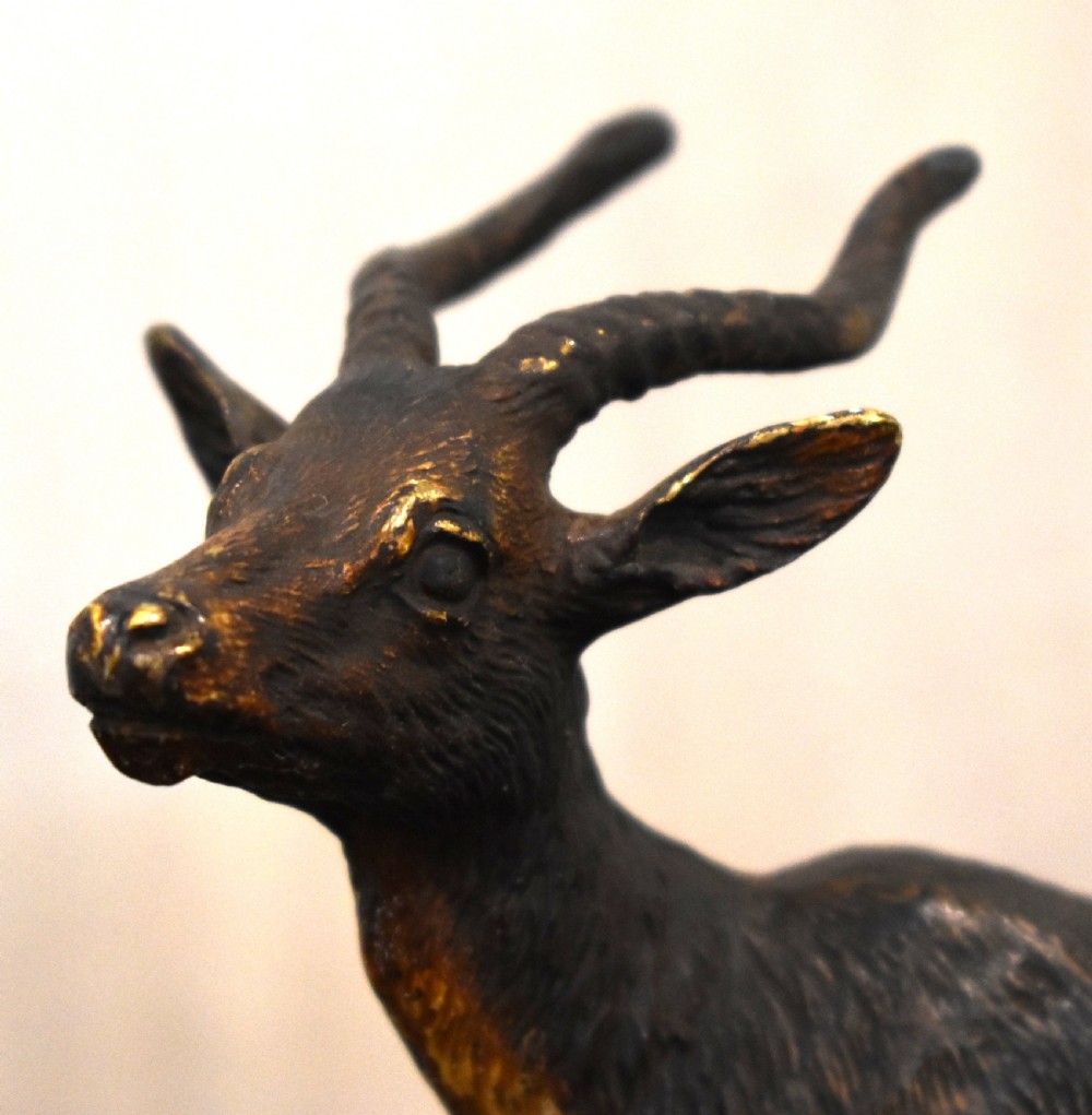An Austrian cold-painted bronze figure depicting an antelope standing in profile with textured fur details and curved horns. View III