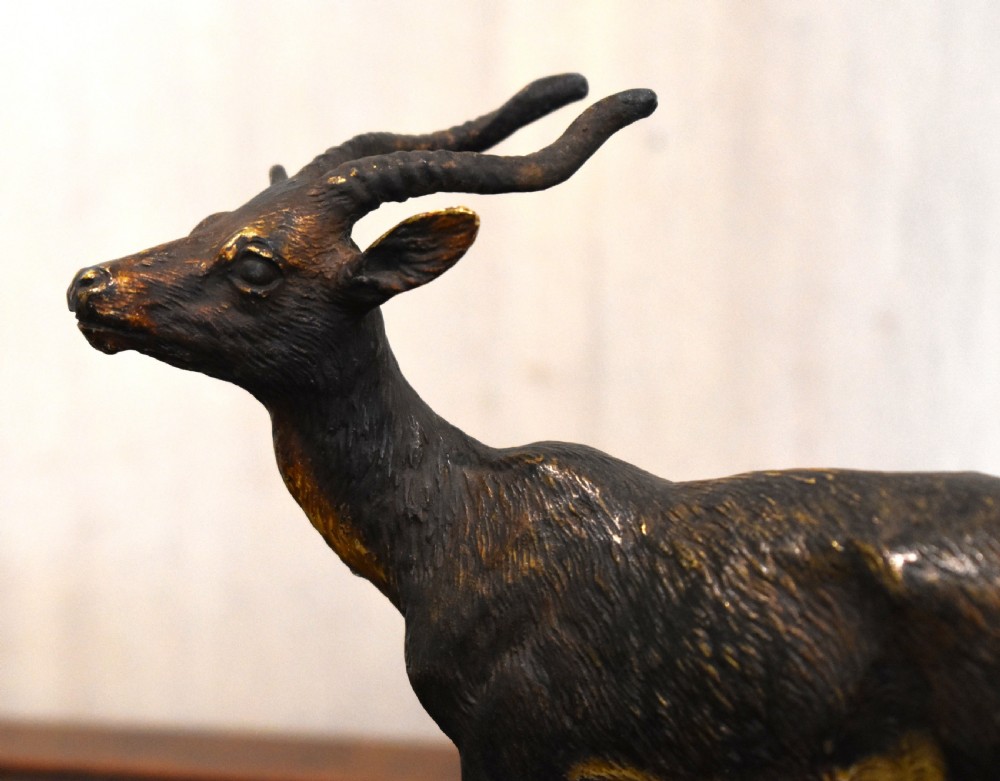 An Austrian cold-painted bronze figure depicting an antelope standing in profile with textured fur details and curved horns. View IV