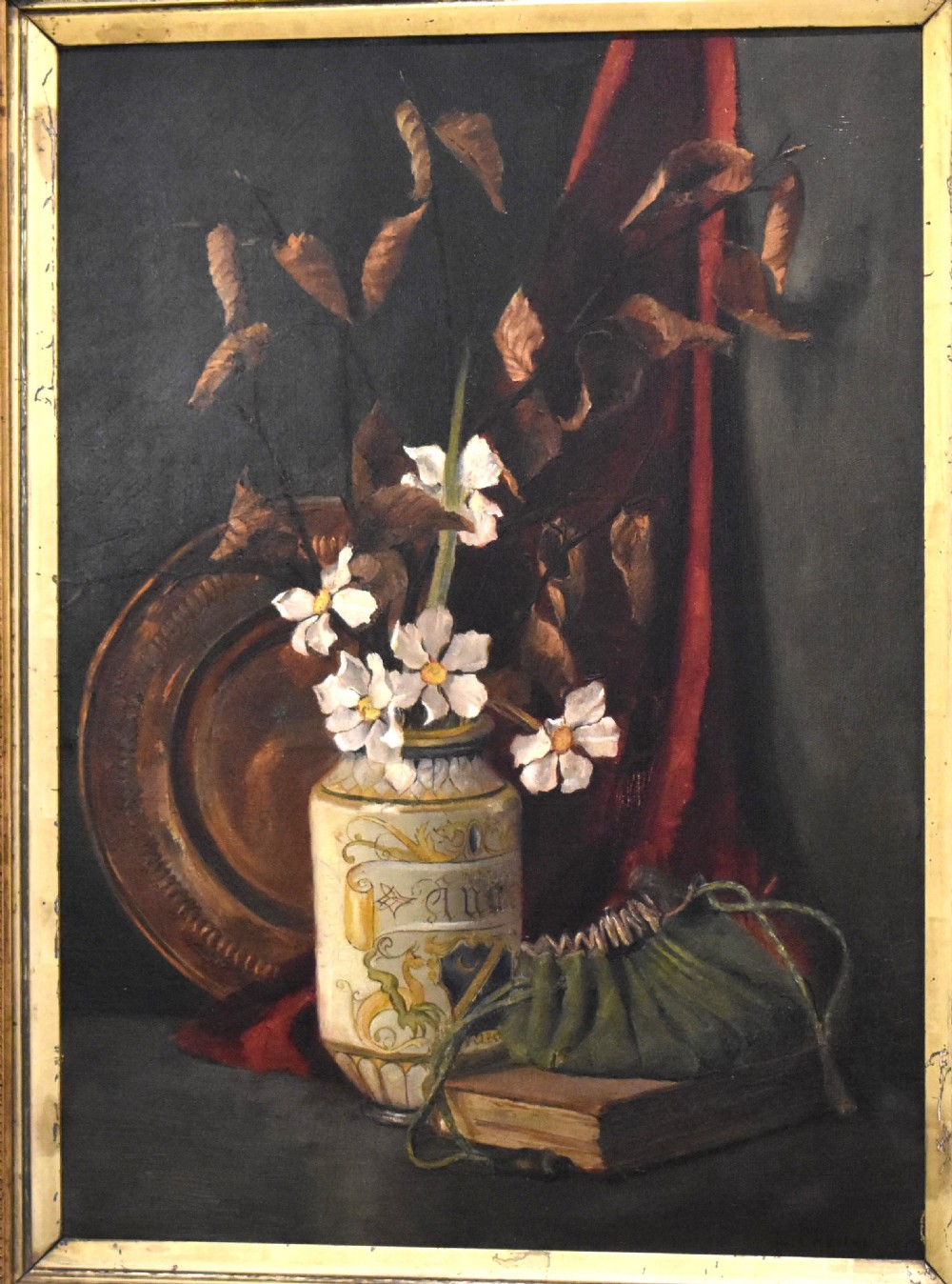 A framed Victorian still life oil painting depicting a ceramic vase with white flowers, a book, and a copper dish against a dark background. View III
