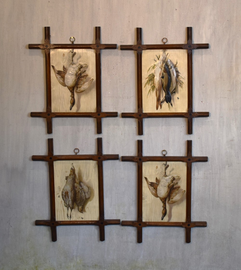 A set of four Victorian embossed prints featuring game birds and fish displayed in dark wooden Oxford frames.