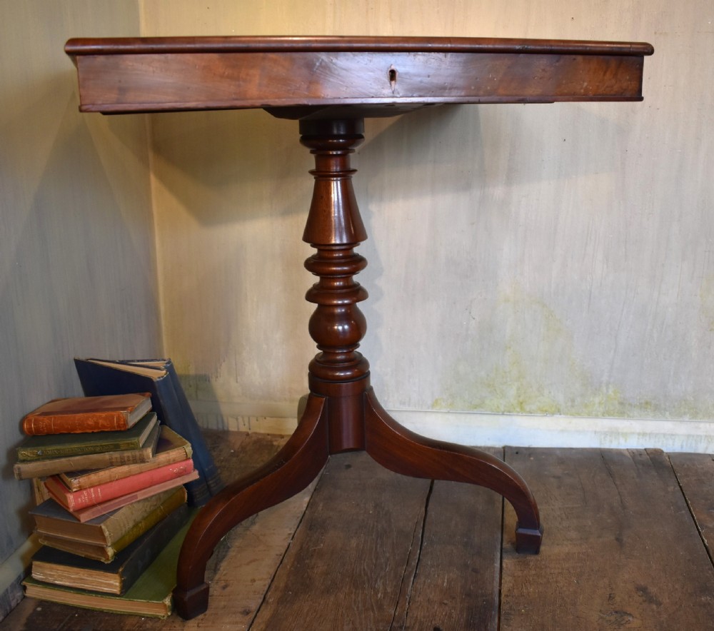 A Georgian mahogany library table featuring a rectangular leather-inset top supported by a turned pedestal stem and tripod swept legs. View II